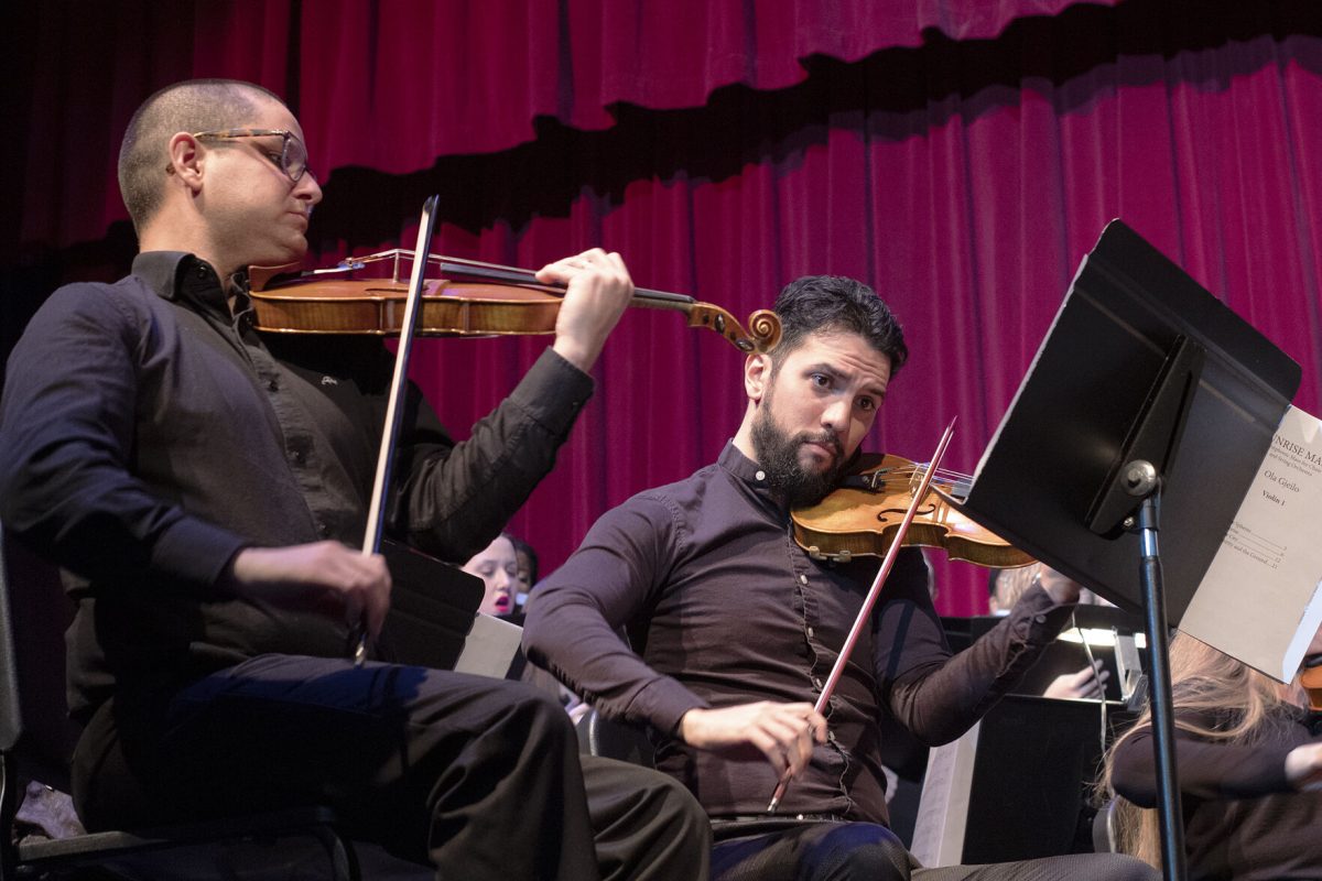 (left to right) Ramiro Miranda and Pablo Campos play the violin during "Sunrise Mass."