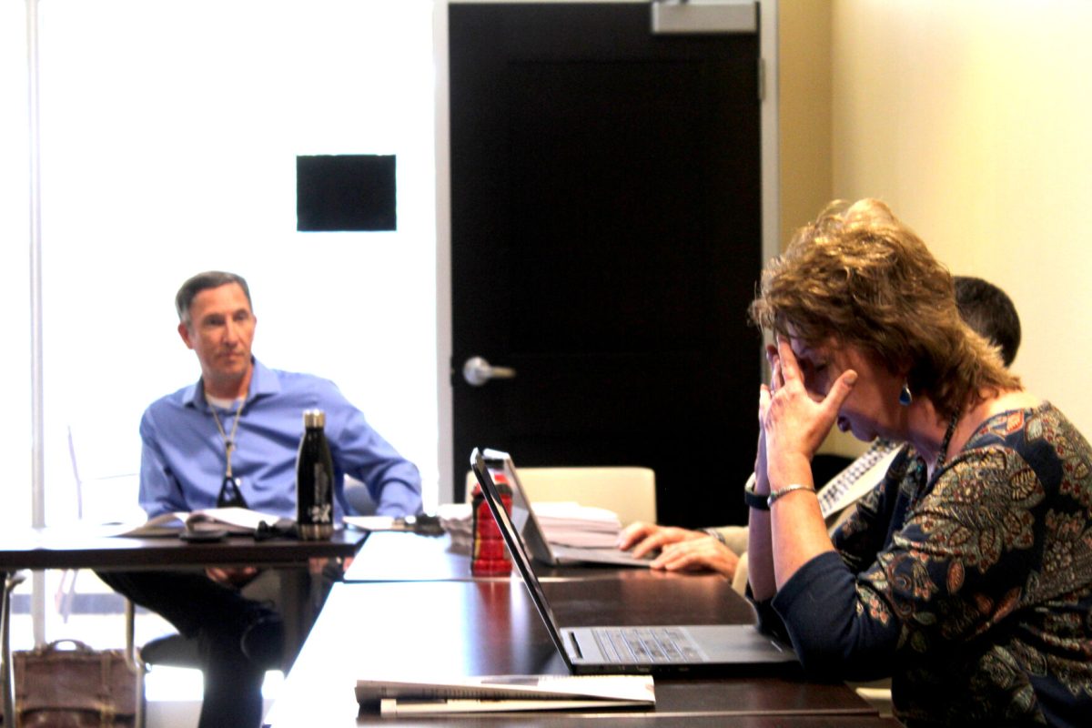 Cynthia Kane, University Libraries and Archives professor&#160;(right) and Shawn Keough (left) discuss the logistics of Friday&#8217;s meeting.