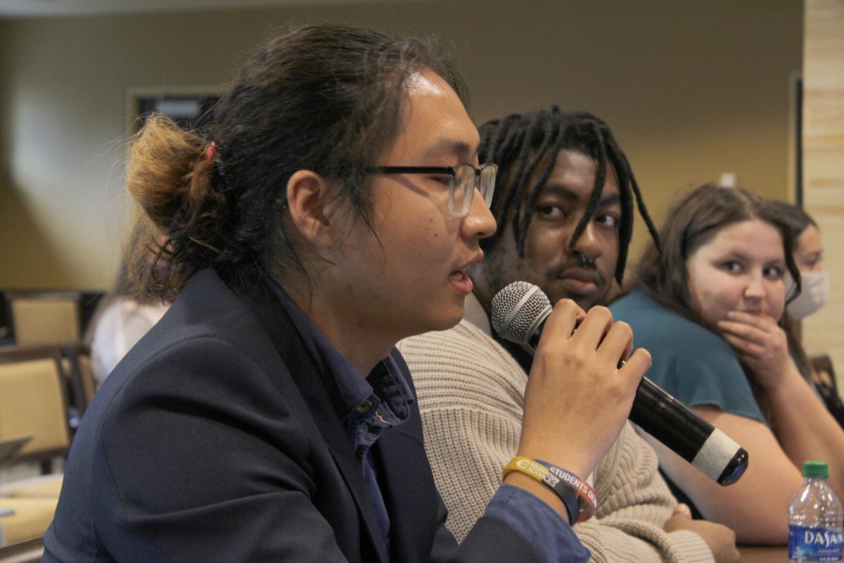 Congwen Wang, ASG senator and SLIM graduate student, expresses his concerns over the recent faculty dismissals. (photos by Noah Eppens)