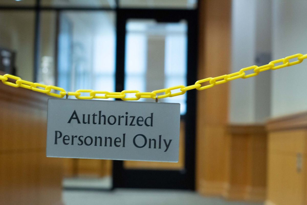 An 'Authorized Personnel Only' sign hangs outside the president's office in Plumb Hall. (photo by Sam Bailey)