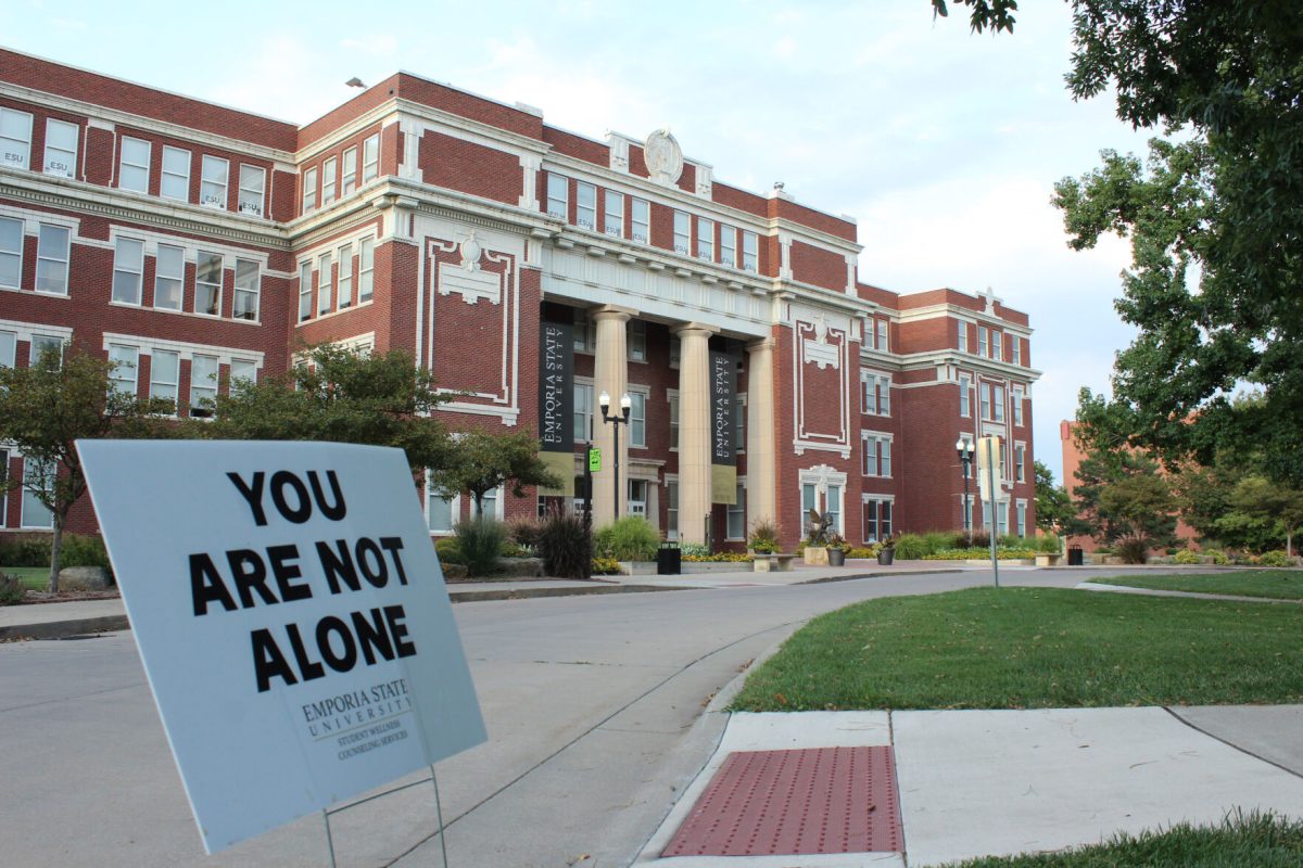 A "You are not alone" sign sits in from of Plumb Hall.