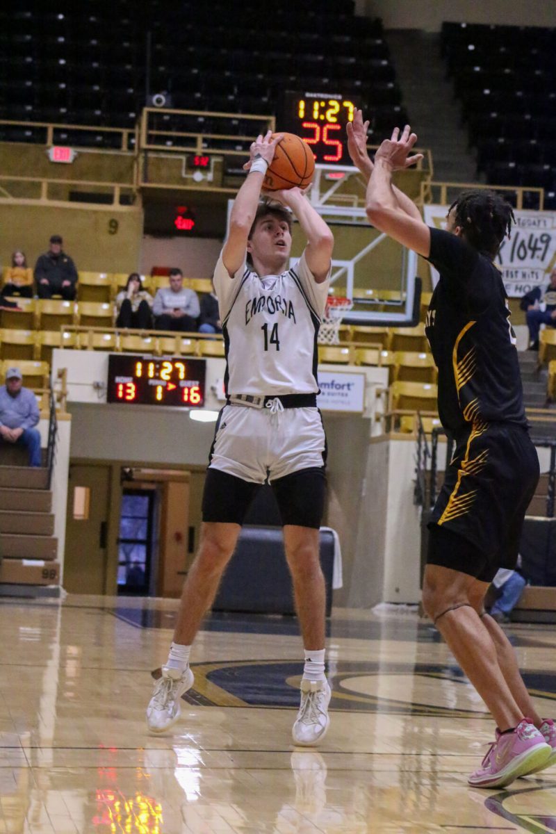 Junior guard Owen Long sinks a crucial three-pointer for Emporia State halfway through the first quarter of play, despite pressure from Fort Hays defender. The Hornets fell to the Tigers 53-74 and are now 15-4 on the season. The hornets will return to action at William L. White Auditorium on January 25 against MIAA foe Northeastern State.&#160;