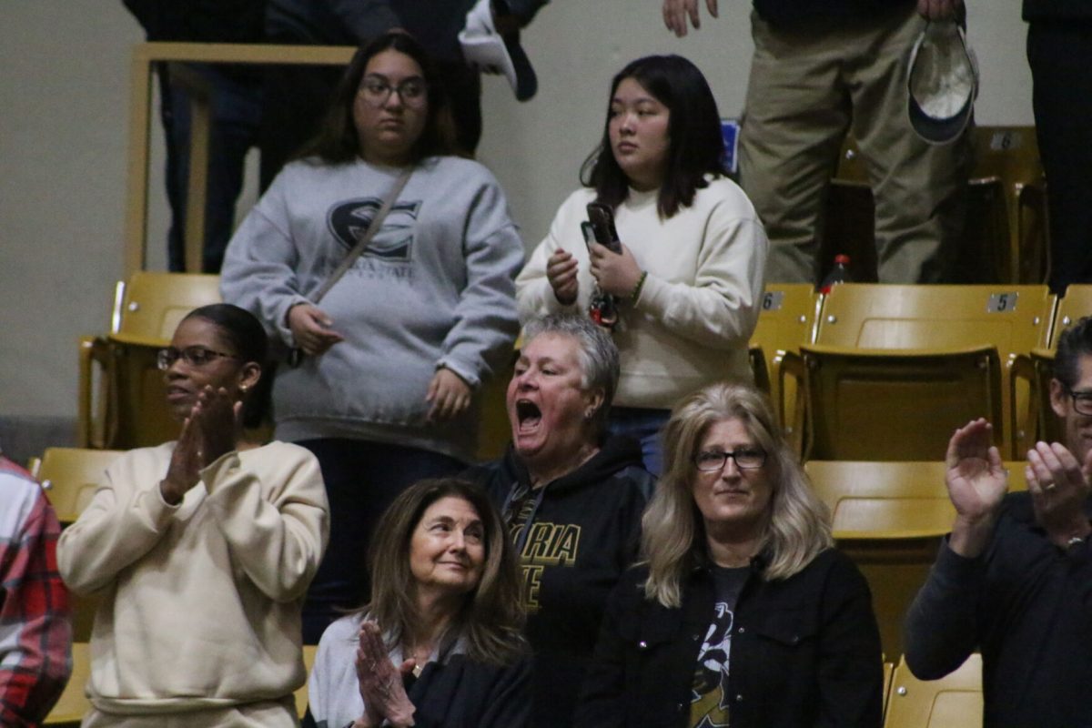 Lorie Rogan stands and applauds the Emporia State men's basketball team at the conclusion of the game against Newman University. The #3 MIAA-ranked Hornets defeated Newman 92-63 on Feb. 11 in White Auditorium.&#160;
