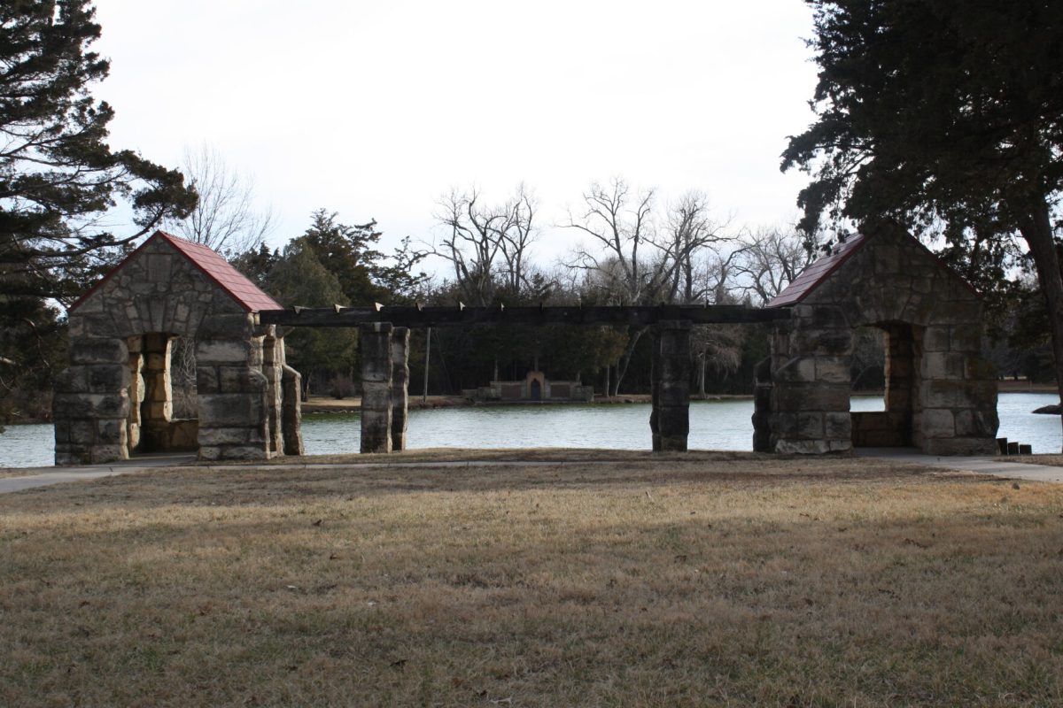 The historic memorial of William Allen White rests at Peter Pan Park watching over the body of water it sits in front of.
