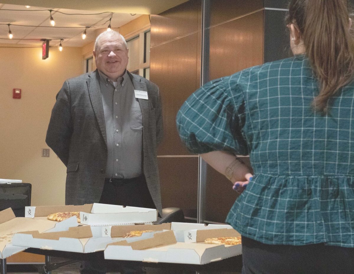 Emporia State Provost Brent Thomas talks to Hailey Kisner, ASG vice president and senior psychology major, during &#8220;Pizza with the Provost&#8221; last Thursday.