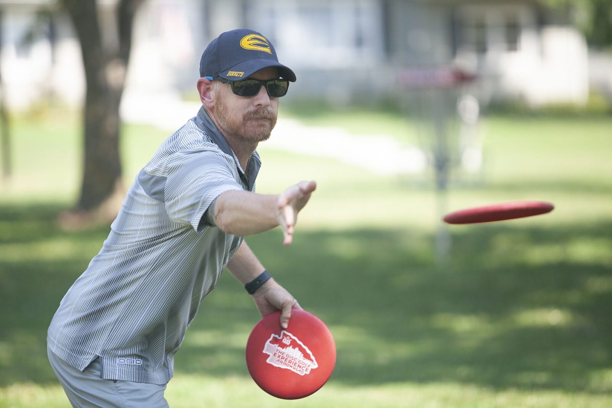 Eric McCabe, head coach of Emporia State disc golf, putts a disc into a practice net Aug. 4 at Jones Park. McCabe is renowned for designing disc golf courses and is a member of Dynamic Discs&#8217;s Board of Directors, according to the ESU Hornets website. He also founded Dynamic Discs Open, then Glass Blown Open, one of the world&#8217;s largest disc golf tournaments