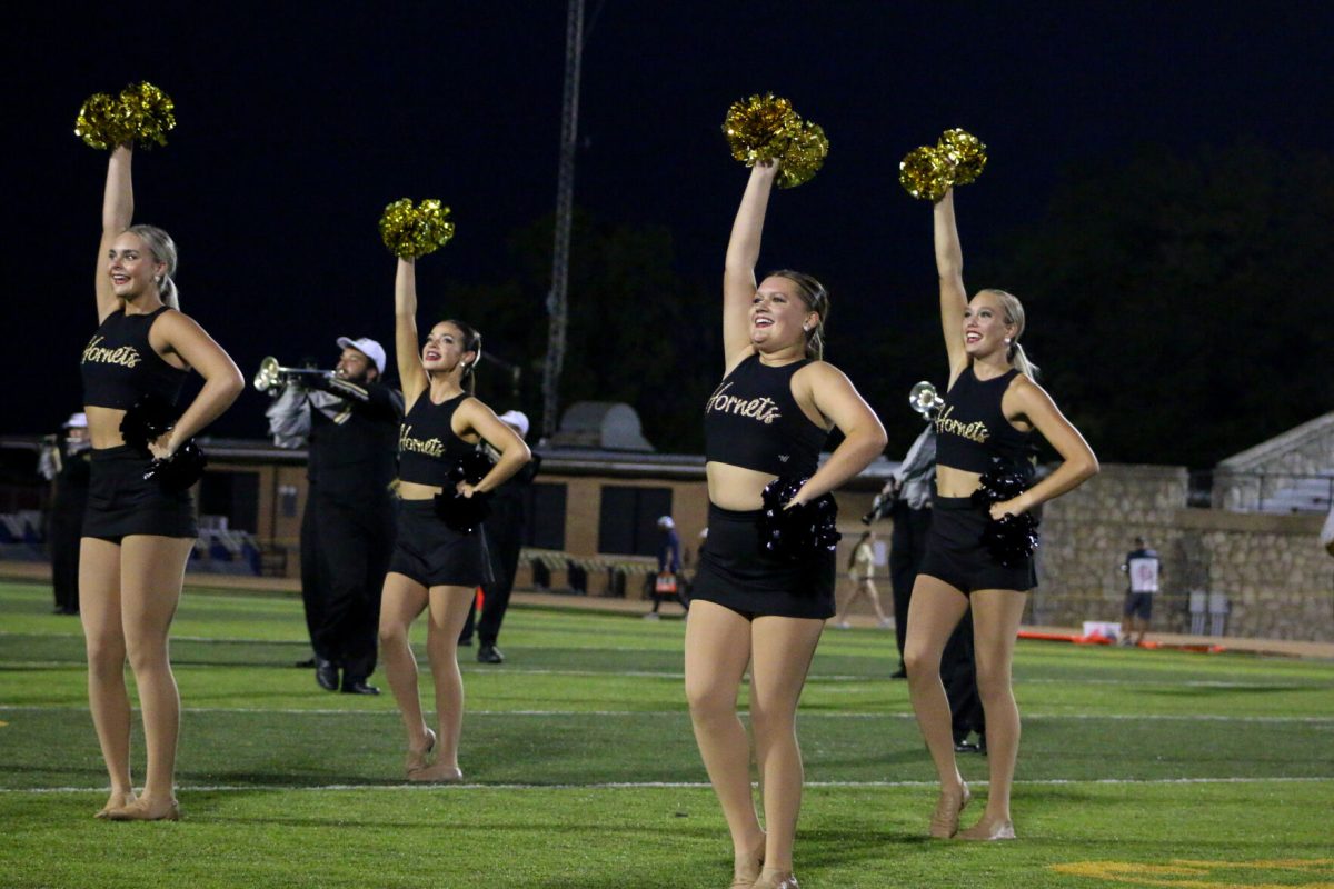 The Stingers dance team performs at halftime of a football game between Emporia State and MIAA rival Lincoln University. During the halftime show, the dance team was accompanied by the ESU band and color guard.