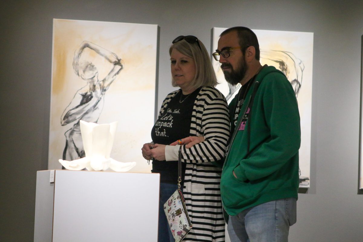 Onlookers view the number of different art exhibits located inside King Hall on&#160;Emporia State Campus on Oct. 6