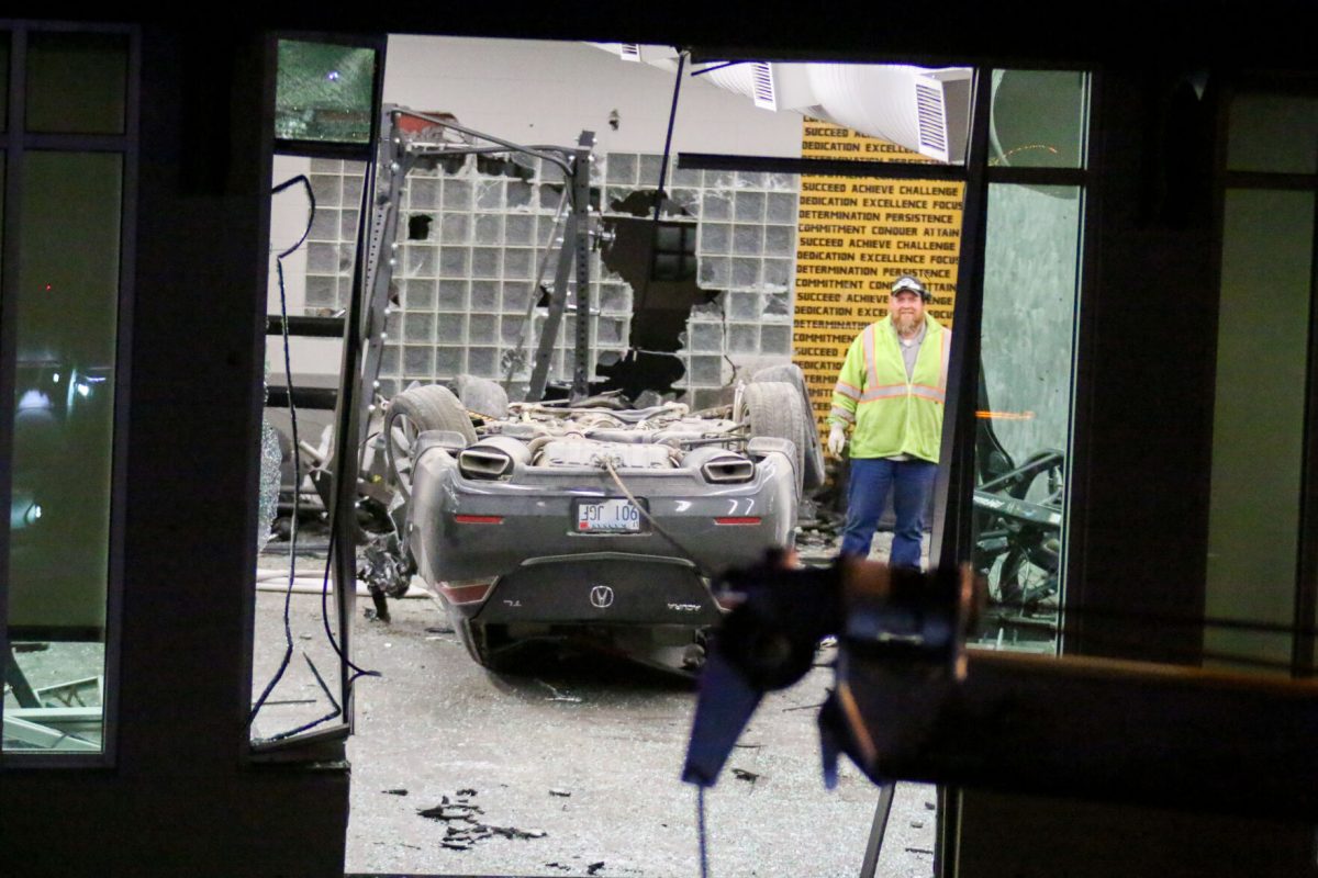 A gray Acura is seen flipped upside down inside the weight room of the ESU student Recreation on Feb. 11.