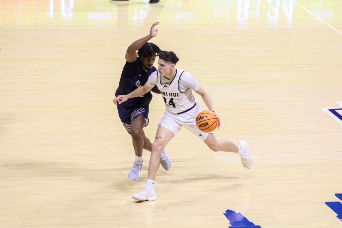 Kaden Evans dribbles down the court during the first round of MIAA Conference Tournament against Lincoln.&#160;