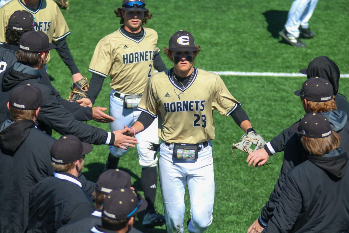 Emporia State dugout gives Andrew Rantz and Kadyn Williams high fives after allowing no scoring from RSU during the fifth inning.