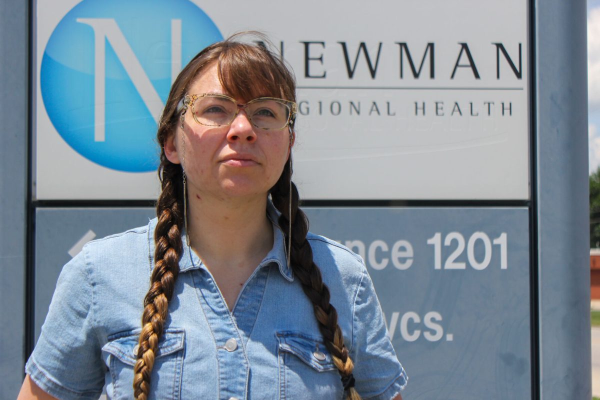 Emeline Fuller stands outside Newman Regional Health on 12th Avenue. For 12 years, Fuller has endured a legal battle with Emporia healthcare providers for bills she "just can't pay."&#160;