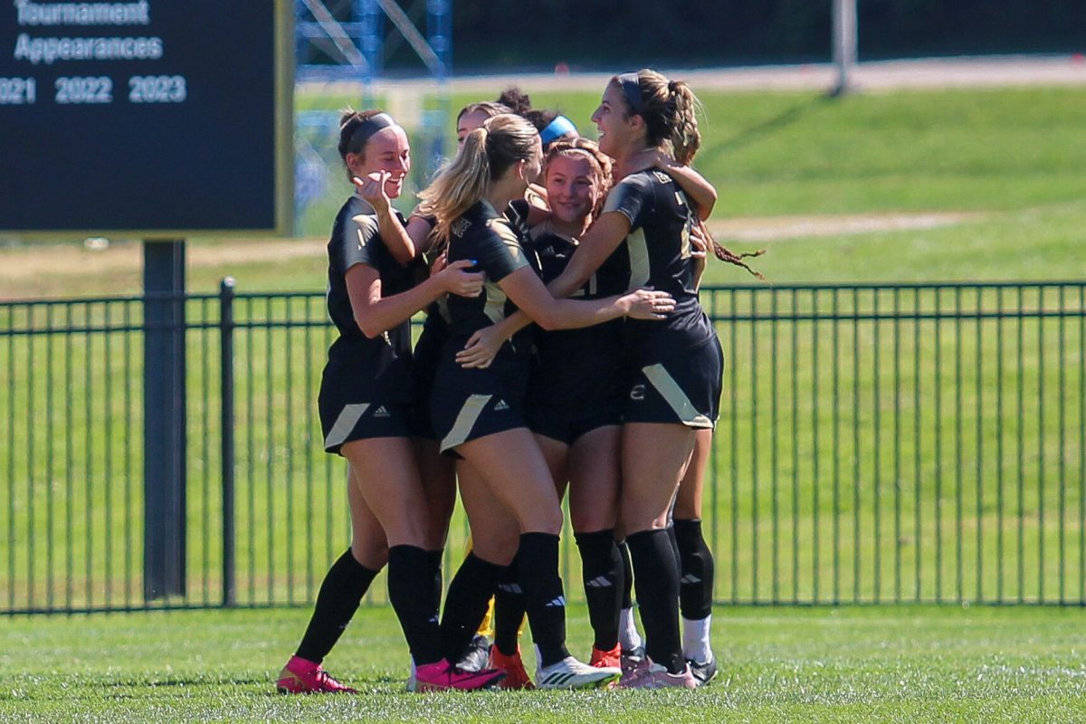 Players group hug on the field during a game against the University of Central Oklahoma on Sept. 29.&#160;