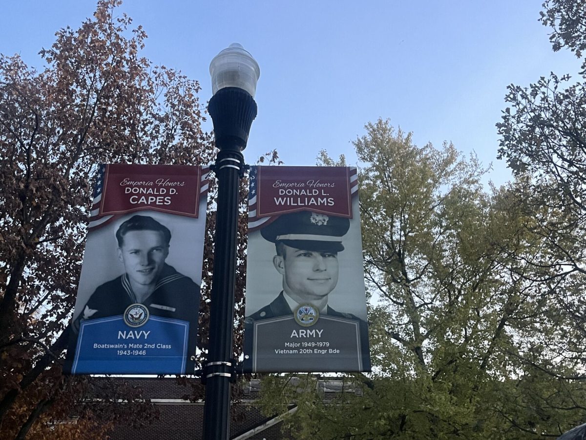 Two veteran banners hang from a lamppost near the arch between King and Beach halls at Emporia State.&#160;