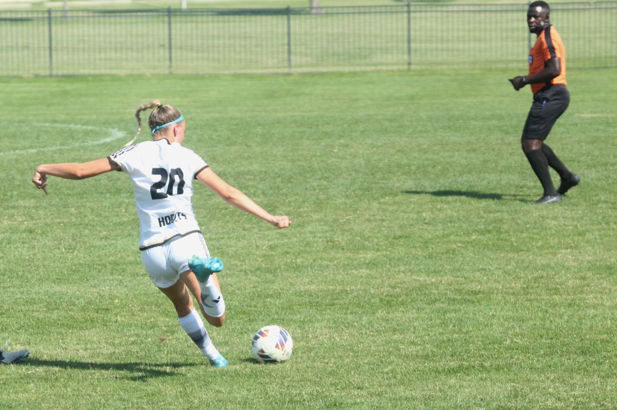 Sophomore defender Aubrey Seltman moves to kick the ball at midfield in a game against Northern University on Sept. 14. 