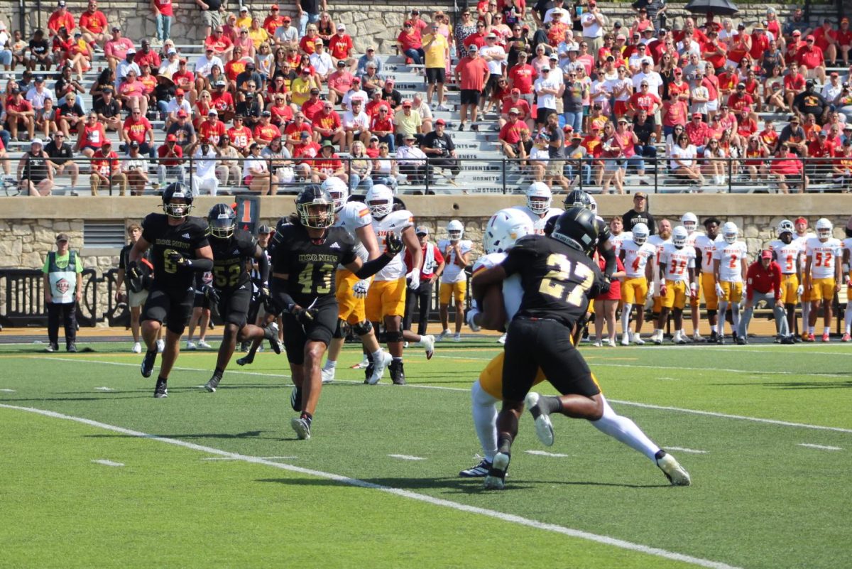 Defensive back Jordyn Harris, a redshirt freshman, goes to tackle a player from Pittsburg State as No. 43 defensive back Nehemiah Figueroa looks on. 