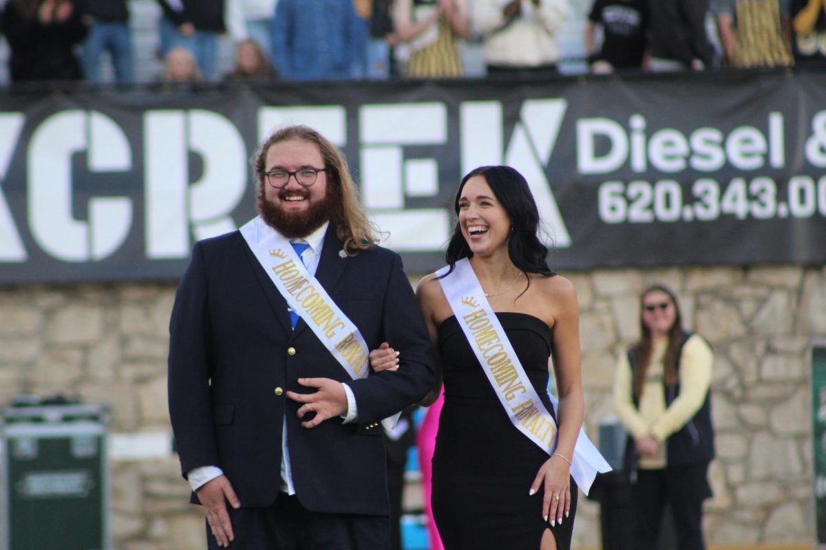 Homecoming royalty Maliki Mosher and Jane Hough laugh together at the halftime crowning ceremony at the Homecoming football game on Nov. 1. 
