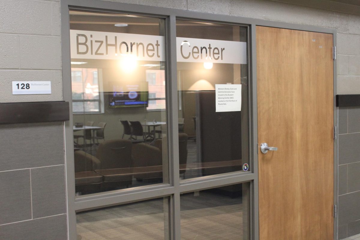 A sign posted on the window of the BizHornet center advises students that Shelby Clark and Jasmine Gonzalez have moved to Plumb Hall. The BizHornet Center provided professional resources for students in the School of Business and Technology.