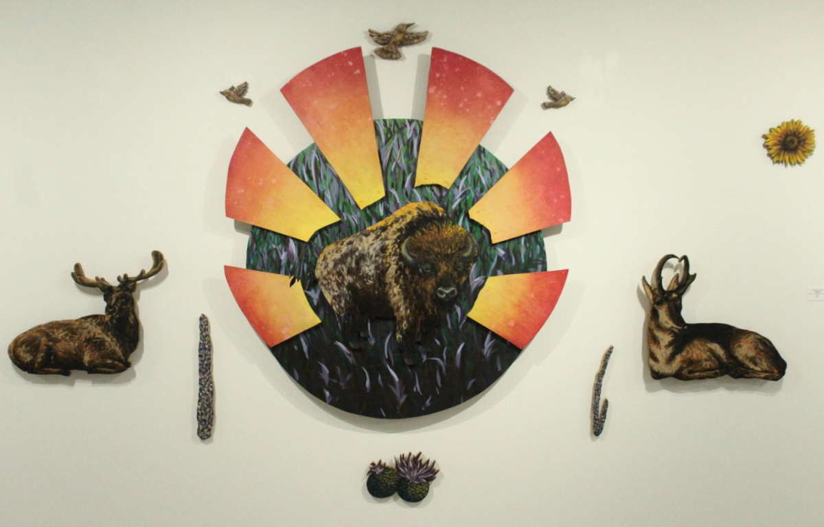 A portrait of a Bison surrounded by flowers, birds, plants and deer, crafted by senior Michael Kidwell, hangs on the wall in Eppink Art Gallery. Kidwell's senior show with senior Sydney Hickman, will run through April 24. 